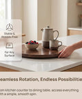 Hand reaching for Top Tier 24 Inch Round Lazy Susan With Dead Smooth 360 Spin, Walnut Veneer Table Top Serving Tray.