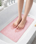 Straight Up Reliable Non Slip Bathtub Mat With Rock Solid Suction Cups Extra Large Bath Rug in pink under wet feet.