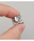 Close-up of Heavy Duty Three In One Connector Eccentric Wheel Hardware held between fingers, nickel plated zinc alloy, silver finish.