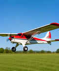 800mm De Havilland Beaver RC Airplane RTF With Gyro 4 Channel 2.4GHz in flight over green field, high visibility red design.