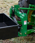 3 Point 10 Cu Ft Dump Box For Category 1 Tractors, green metal frame attached to rear wheel on a farm field