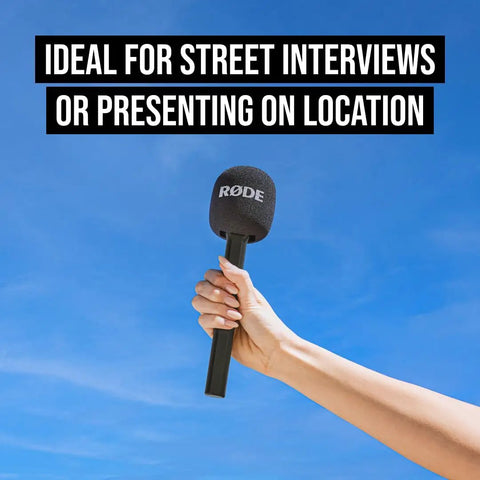 Interview GO Handheld Adaptor For Wireless ME GO And PRO Transmitters held against blue sky with removable windshield and handle
