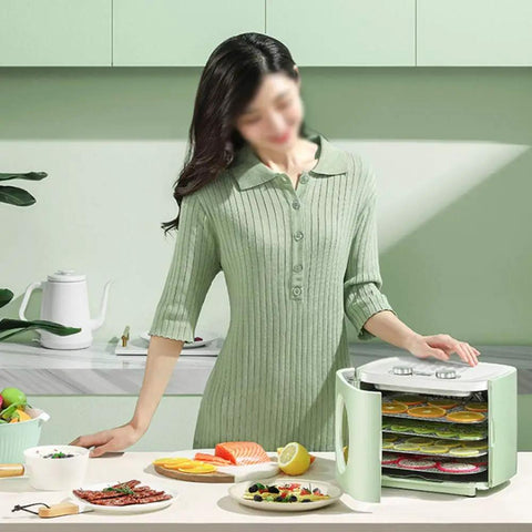 Electric Food Dehydrator Stainless Steel Beef Jerky Maker And Vegetable Dryer With 360 Circulating Air Automatic Cooling used in a kitchen with fresh snacks.