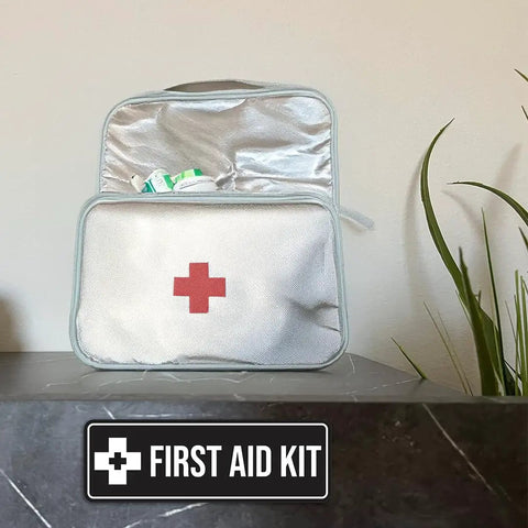 Durable Navy Blue And White First Aid Kit Sign displayed next to an open first aid kit bag on a table