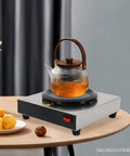 Straight Up Coffee Pot Warmer Hot Plate Keeping Daily Brews And Teas Properly Toasty With Reliable Eighty Watt Steady Heat For Kitchen Counters Or Office Desks Smooth Vibes For Kickback Gatherings And Cafes with a glass teapot.
