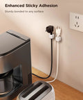 9 Pack Magnetic Cable Clips For Easy Cable Management Under Desk And On Walls installed holding cables on wall near appliances
