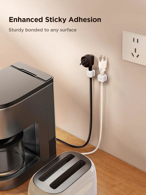 9 Pack Magnetic Cable Clips For Easy Cable Management Under Desk And On Walls installed holding cables on wall near appliances