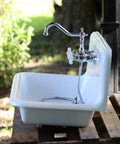 Heritage Wall Mount Kitchen Faucet 8 Inch Spread Polished Chrome Solid Brass Construction installed on white sink outdoors