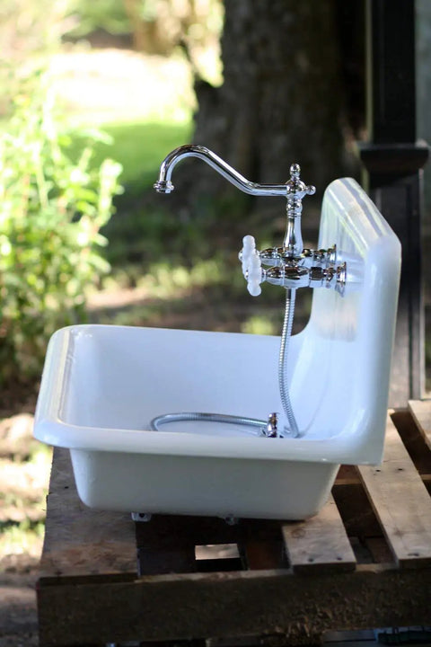 Heritage Wall Mount Kitchen Faucet 8 Inch Spread Polished Chrome Solid Brass Construction installed on white sink outdoors