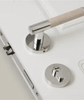 Lychee Skin Door Lock Set In Brass Gray with dummy handle on white interior door.
