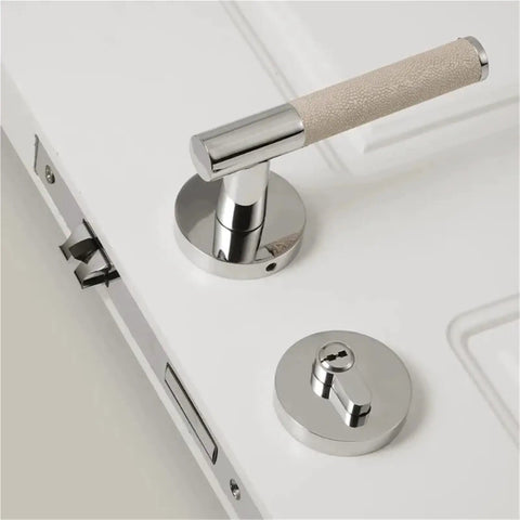 Lychee Skin Door Lock Set In Brass Gray with dummy handle on white interior door.