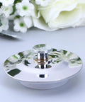 Stainless Steel Bathtub Stopper for 40-45mm Drain Holes topped with a shiny central knob, reflecting light beautifully.