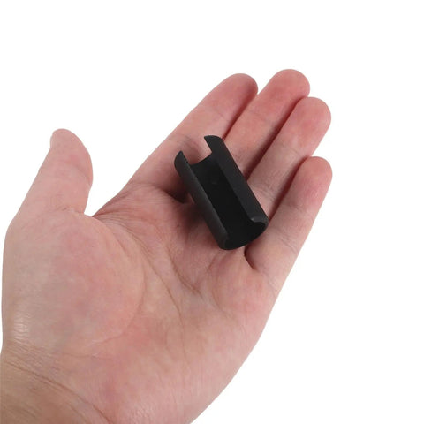 Hand holding a single black plastic piece from U Shaped Floor Glides For Sled Base Chairs 20 Pack, Plastic Chair Pads And Furniture Feet Protectors