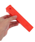 Heavy Duty Red Leveling Wedges 20 Pack Polymer Shims For Window And Furniture Installations Moistureproof Gap Fillers held in hand.