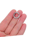 Hella Tough Stainless Steel Spring Lock Washers Assortment Kit With 100 Heavy Duty Fasteners in hand showing a single washer.