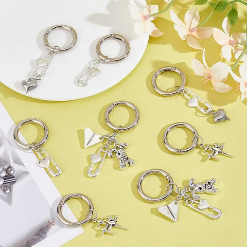 Fresh Safety Pin Shoe Charms With Sturdy Spring Clips And Alloy Badges Featuring Star Heart Rabbit Designs For Boots Bags And Purse Gear on a yellow background.