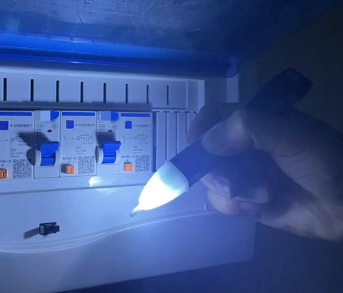 Person using Non Contact Voltage Tester Pen With Led Flashlight And Buzzer Alarm AC Voltage Detector From 60V To 1000V on breaker panel