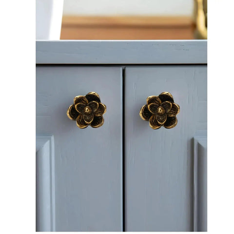 Six Pack Gold Antique Knobs Vintage Floral Flower Handle Cabinet Knobs on gray cabinet doors.