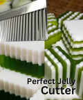 UNCLEJUM Crinkle Cutter serrated knife in stainless steel slicing green and white jelly blocks (close-up)