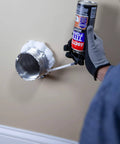 Applying Big Gaps Spray Foam Sealant That Expands To Fill And Insulate Up To Three Inches, 12 Fl Oz Can, around a metal duct opening