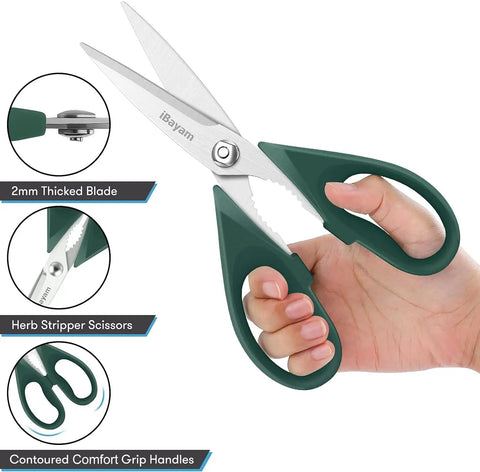 Person holding heavy duty kitchen scissors with stainless steel blades and green comfort grip handles.