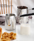 Milk Frothing Pitcher 20oz Stainless Steel No Drip Spout Long Handle Turkish Coffee Pot Frother For Espresso Machine Latte Art Cappuccino Foam Milk Jug 600ml Perfect For Home Barista Coffee Lovers on a kitchen counter