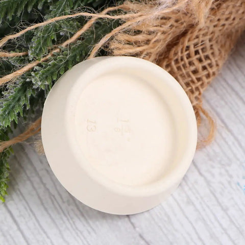 4pcs Bathtub Stopper Rubber Plug with Hanging Ring beige rubber plug viewed from above resting on a wooden surface.