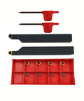 Front view of two red lathe turning tool holders with RCMT0602 carbide inserts in a red storage case