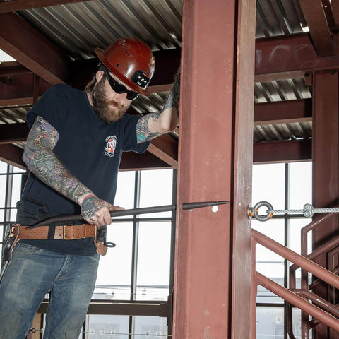 Worker using Ergonomic Round Connecting Bar 7/8 Inch Wide By 30 Inch Long With 15 Degree Angled Chisel, Tapered End.