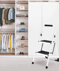 Foldable 2 Step Ladder With Handgrip And Anti Slip Wide Pedals Built Like A Tank For Adults Sturdy Stepladder in front of closet