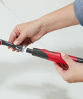 Attachable Grout Head For Cordless Power Scrubber Battery Powered Scrub Brush Attachment being attached with two hands