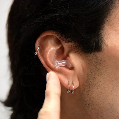 Close-up of a person wearing Flight Ready Earplugs For Ear Pressure Relief On Flights Pain Free Takeoffs And Landings Cut Cabin Noise And The Hum Of Engines Comfortable Fit For Men And Women Essential Air Travel Gear For A Smoother More Chill Flight Experience.