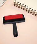 Solid Grip Rubber Paint Roller For Printmaking And Classroom Art Projects featuring a red rubber roller on a minimalistic black handle