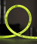 Air Hose Half Inch By 100 Feet Heavy Duty Lightweight Hybrid With Half Inch MNPT Fittings ZillaGreen in a loop on a table
