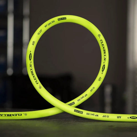 Air Hose Half Inch By 100 Feet Heavy Duty Lightweight Hybrid With Half Inch MNPT Fittings ZillaGreen in a loop on a table