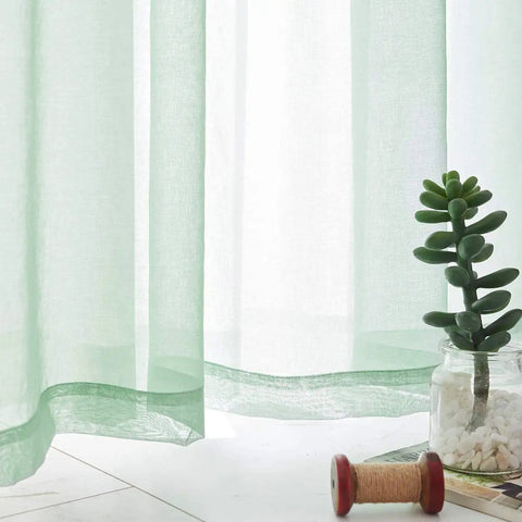 Close-up of Christmas Green Semi Sheer Curtains with linen look, light filtering, featuring durable fabric, in a cozy home setting.