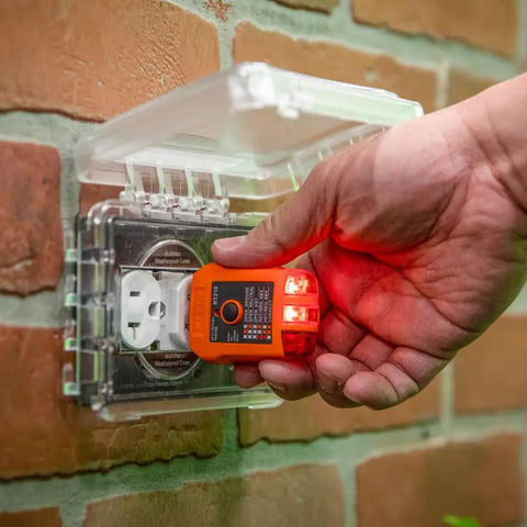 Hand holding GFCI outlet tester from Ultra Handy Electrical Test Kit With Digital Clamp Meter And Non Contact Voltage Tester