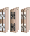 Heavy Duty Hidden Door Hinge For Sleek Invisible Panels With Three D Adjustability And Smooth One Eighty Degree Flat Folding For Rock Solid Mounting And No Sweat Assembly. View of three hinges with silver and black finishes, mounted on wood panels.