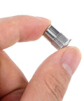 Close-up of Stainless Steel Flat Head Knurled Rivet Nut from 1/4-20 Thread Rivet Nut Inserts Kit, held between fingers.