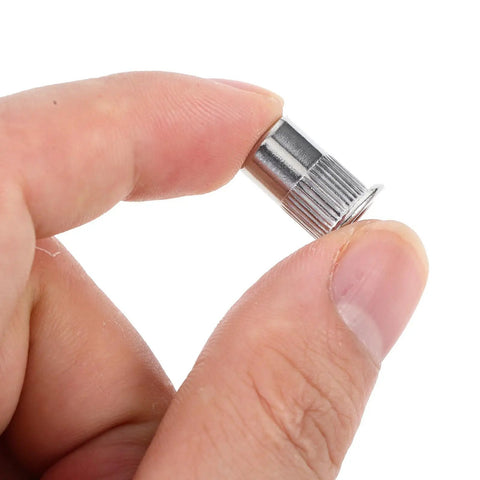 Close-up of a Heavy Duty Stainless Steel Flat Head Knurled Rivet Nut from the Kit with 1 4 20 Thread Inserts in hand, 120 pieces included
