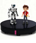 360 Electric Turntable Rotating Display Stand With Knob Control USB Power Base For Jewelry Shoes And Glitter Cups Shooting White 16 inch displaying a robot and a boy figure.