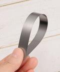 Mn steel feeler gauge blade, 0.2 mm thick, 150 mm long, held between fingers.