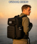 Man wearing rugged military tactical backpack for men with MOLLE webbing, water bottle holder, for hiking at sunset.