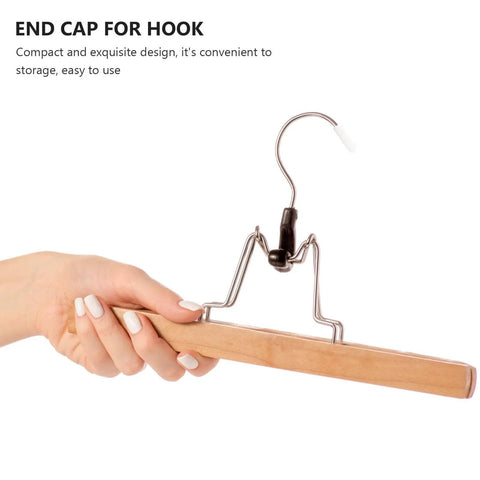Hand holding a wire hanger with 300 Pack Plastic White Clothes Hanger End Caps With Rounded Corners No Glue Needed Protective Covers.