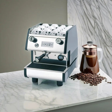 Hardcore Pro Programmable Espresso Maker Featuring Digital Touch Controls And Precision Volumetric Dosing For Dead Smooth Shots Heavy Duty Brass Group Head Matte Black Finish on marble countertop with coffee beans and a French press.