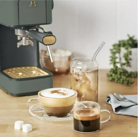 Rock Solid Compact Espresso Machine In Fresh Thyme Green with espresso and latte drinks on a wooden table.