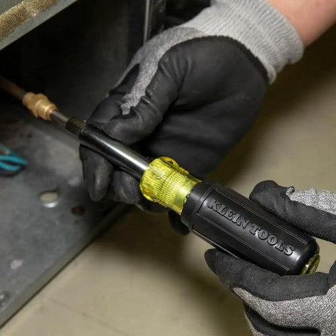 Technician using 11-In-1 Multi-Bit Screwdriver And Nut Driver For HVAC Pros with Phillips Slotted Square and Schrader Bits