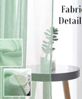 Close-up of mint green Christmas Green Semi Sheer Curtains With Linen Look Light Filtering Rod Pocket Panels hanging by a small table.