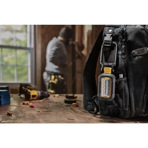 Beast Mode 1000 Lumen LED Work Light With Magnetic Handle USB C Rechargeable installed on workshop bag, blurred background.