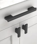 Close-up of 10 Pack 5 Inch Matte Black Cabinet Pulls for Cupboards and Drawers installed on white cabinet